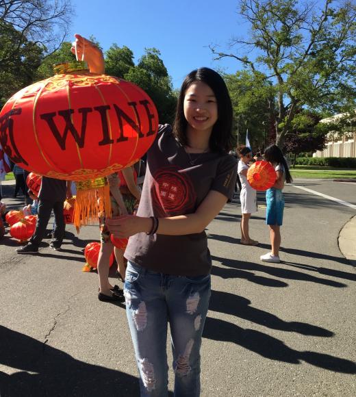 Li Liao holds a red and gold lantern.